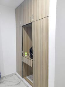 a wooden cabinet with a glass door in a room at Mwembeni Abode in Bamburi