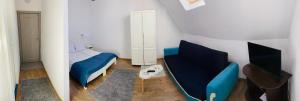 a bedroom with a bed and a couch and a chair at Pensiunea Craiul Muntilor-Ranca in Ranca