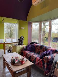 a living room with a couch and a table at Heavenlywell in Geel