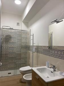 a bathroom with a toilet and a sink at BM Flowers in Tropea +77 photos