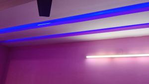 a room with purple and blue lights on the wall at Hotel rishav prime in Ghaziabad +1 photo