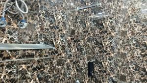 a bathroom with a marble wall with a shower at Hotel rishav prime in Ghaziabad