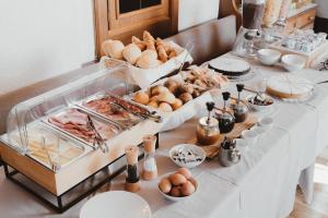 a table with a buffet of food on it at Locanda dal Giulio al Fratè B&B in Madonna di Campiglio +74 photos