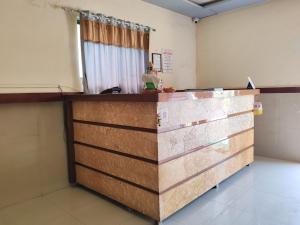 a counter in a room with a person standing behind it at Hotel Krantiveer in Kālundri
