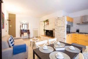 a living room with a couch and a table at Blueberry Villa - Historic Center Lago Maggiore in Luino