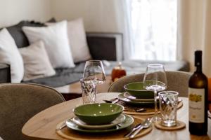 a table with two glasses and a bottle of wine at El Koulador House in Ialysos