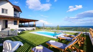 a backyard with a swimming pool and lawnitures at Villa AD Astra by Villas Guide in Sesvete