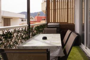a table and chairs on a balcony with a view at El Koulador House in Ialysos