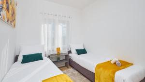 a bedroom with two beds and a window at Villa AD Astra by Villas Guide in Sesvete +21 photos
