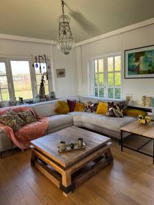 a living room with a couch and a coffee table at Heavenlywell in Geel