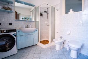 a bathroom with a washing machine and a toilet at Blueberry Villa - Historic Center Lago Maggiore in Luino +23 photos