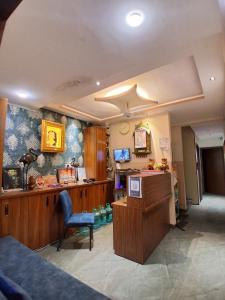 a room with a counter and a chair in it at HOTEL RAJBHOG indore in Indore