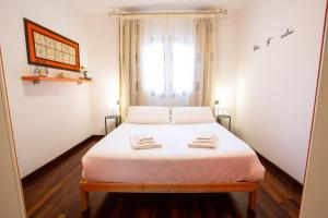 a bedroom with a bed with two towels on it at Blueberry Villa - Historic Center Lago Maggiore in Luino