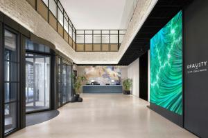 a hallway in a building with a large mural on the wall at GRAVITY JOSUN Seoul Pangyo, Autograph Collection in Seongnam