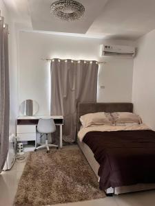 a bedroom with a bed and a table and a desk at Casa Flores in Sampong