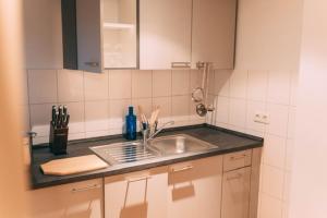 a kitchen with a sink and a counter top at Haus im Garten in Stockach +23 photos