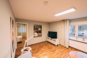 a living room with a television and a table at Haus im Garten in Stockach