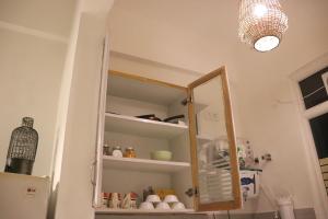 a cabinet with a mirror in a kitchen at Gypsy Soul Gateaway in Zirakpur +4 photos