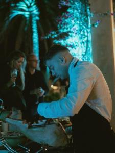 a man standing in front of a table with people at Villa My Love Mallorca in Bunyola +101 photos