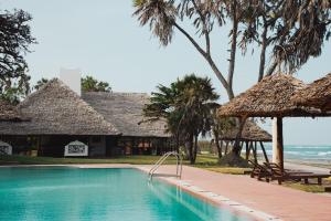 a swimming pool in front of a resort at Amani Beach Resort in Dar es Salaam +21 photos