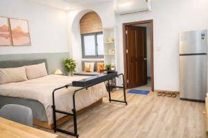 a bedroom with a bed and a refrigerator at START HOUSE AIRPORT 5-MIN WALK Warm Stay, Easy Flight in Ho Chi Minh City