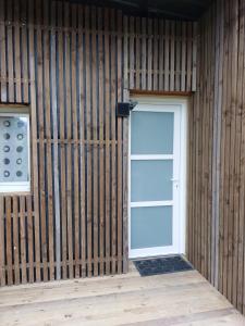 a door in the side of a wooden building at Maisonnette individuelle in Figarol