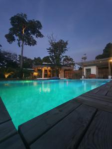 a swimming pool with blue water at night at Casa Ysatis in San Juan