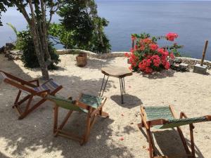 a group of chairs and a table on the beach at Casa Ysatis in San Juan