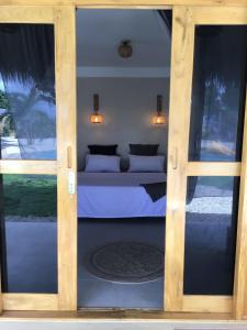 a bedroom with a bed and two windows at Casa Ysatis in San Juan