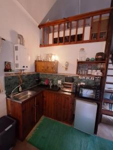 a kitchen with wooden cabinets and a sink at Bubuhle Self Catering Cottage in Hogsback