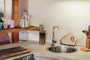 a kitchen counter with a sink in a kitchen at Seabreeze Suite in Füssen