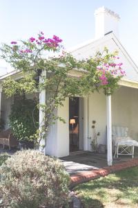 a house with pink flowers on the front porch at Way's Cottage in McLaren Vale