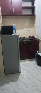 a small refrigerator in a kitchen with a counter at Dee Holiday Homes Studio-Bamburi Total in Mombasa