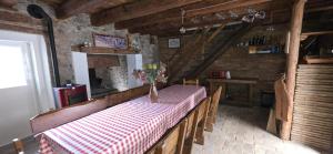 a dining room with a table with a vase of flowers on it at Casa APOLLO in Palmanova +5 photos