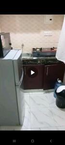 a kitchen with a stove and a sink in it at Dee Holiday Homes Studio-Bamburi Total in Mombasa