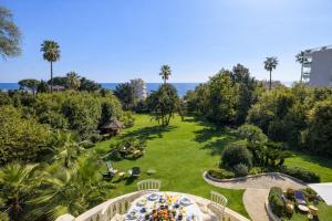 an aerial view of a garden with palm trees at Villa Alexandra by Sweett in Cannes