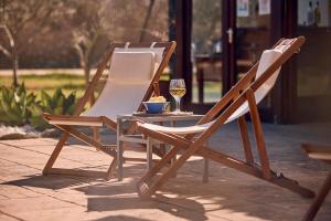 two chairs and a table with a glass of wine at S'Hort de Son Caulelles - Adults Only in Marratxí  +73 photos