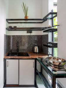 a kitchen with a sink and a counter top at Mashmellow Resort and Spa in Galle