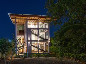 a building with a staircase in front of it at night at Mashmellow Resort and Spa in Galle