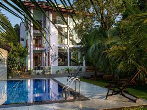 a house with a swimming pool next to a building at Mashmellow Resort and Spa in Galle