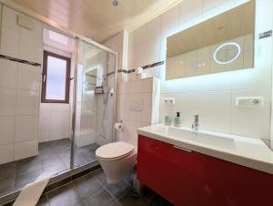 a bathroom with a toilet and a shower and a sink at Chic Alpine Oasis in Oberammergau with Mountain View in Oberammergau