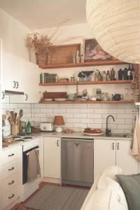 a kitchen with white cabinets and a sink at Way's Cottage in McLaren Vale