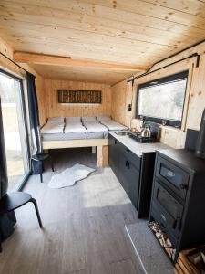 a kitchen in a tiny house with a sink at Maringotka pod Smrkem in Nové Město pod Smrkem