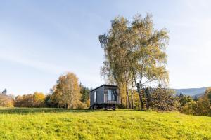 a tiny house on a hill in a field at Maringotka pod Smrkem in Nové Město pod Smrkem