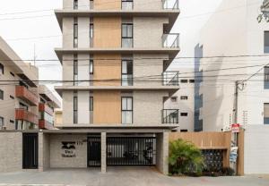 a tall building with a gate in front of it at Apartamento Flat, Incrível, 250 M da Praia in Cabedelo