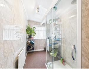 a bathroom with a shower and a glass shower stall at The Bishop Bolthole in Bishop Auckland