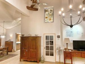 a living room with a chandelier and a dining room at A Soulas in Armous-et-Cau