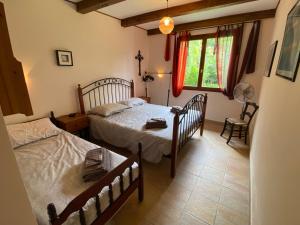 a bedroom with two beds and a window at A Soulas in Armous-et-Cau +76 photos