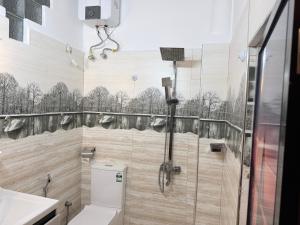 a bathroom with a shower with a toilet and a sink at Home Stay Residence - Near Airport in Negombo +17 photos