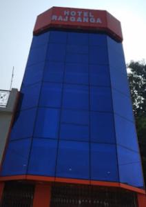 a blue building with a sign on top of it at Hotel Rajganga in Gonda +9 photos